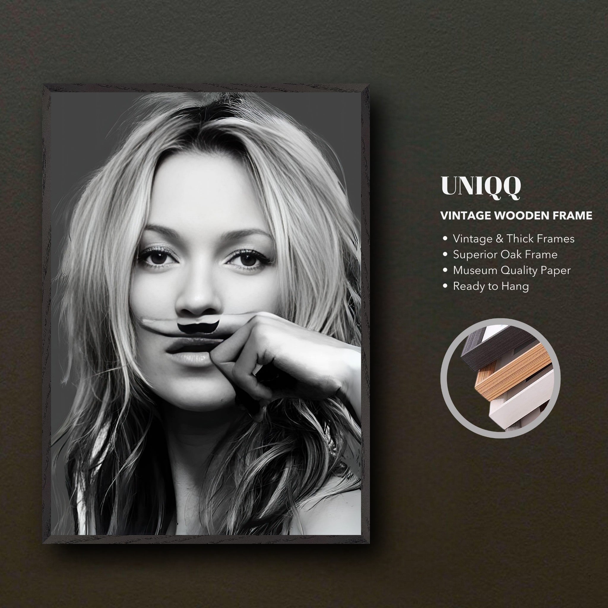 Vintage framed print of Kate Moss with a playful mustache, showcasing high fashion and humor in black and white.