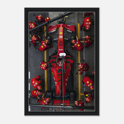 Framed canvas print of a Ferrari Formula 1 pitstop with vibrant colors and dynamic racing action.