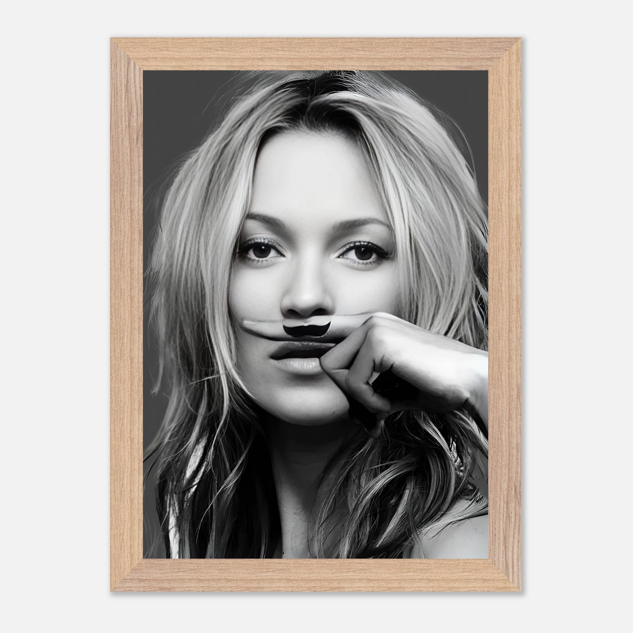 Kate Moss vintage framed print featuring a playful mustache in a black-and-white portrait. Perfect for stylish wall decor.