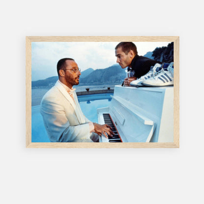 Jean Reno piano scene framed print featuring iconic moment from "The Big Blue" with ocean backdrop and soft hues.