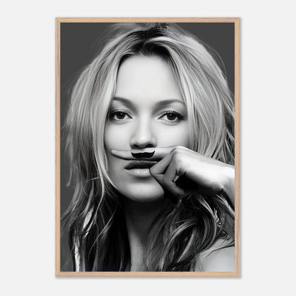 Black-and-white vintage framed print of Kate Moss playfully posing with a drawn mustache.