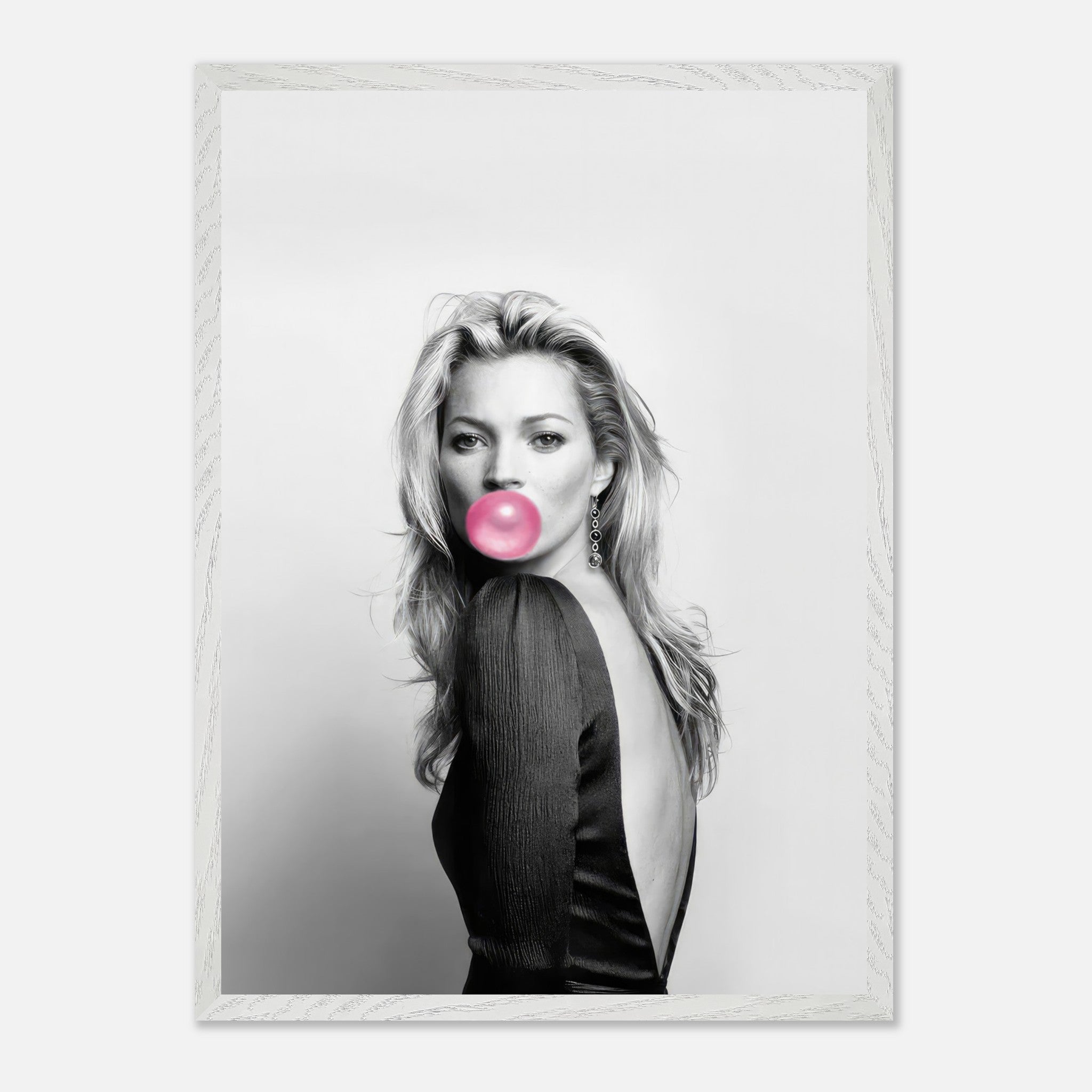 Vintage black-and-white portrait of Kate Moss blowing pink bubble gum in a stylish black outfit.