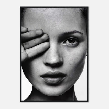 Black and white portrait of a model covering one eye with her hand, exuding elegance and sophistication in framed print.