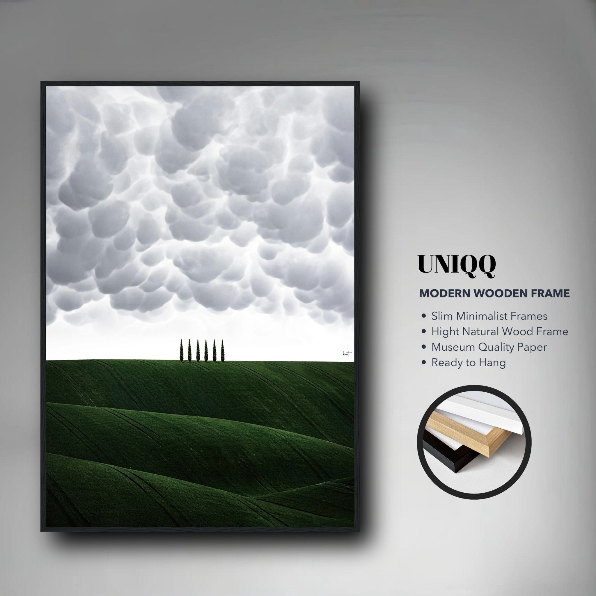 Framed print of Tuscany, featuring green hills and cypress trees under dramatic clouds, in a modern wooden frame.