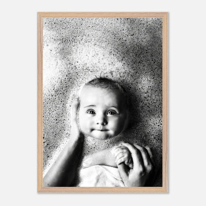 Vintage framed print of a baby smiling in a bubble bath, showcasing childhood innocence in black and white.