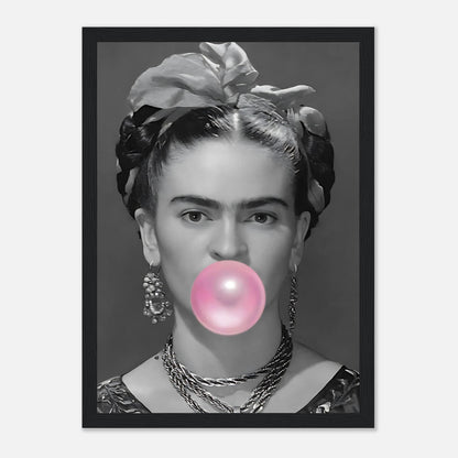 Frida Kahlo framed print featuring her blowing pink bubble gum in a black and white portrait style.