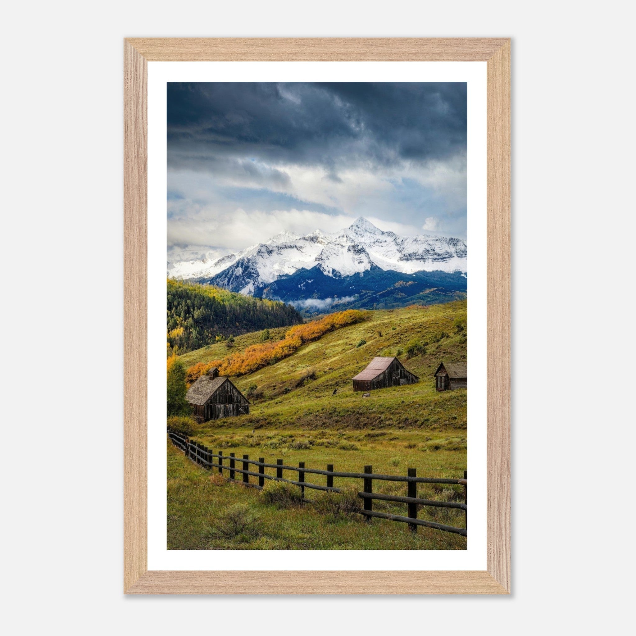 Framed Giclée fine art print of Telluride, Colorado, showcasing rustic barns and snow-capped mountains in a vibrant landscape.