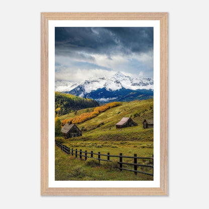 Framed Giclée fine art print of Telluride, Colorado, showcasing rustic barns and snow-capped mountains in a vibrant landscape.