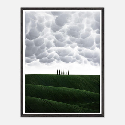 Toscana vintage framed art featuring green hills and cypress trees under dramatic clouds. Perfect for enhancing living spaces.