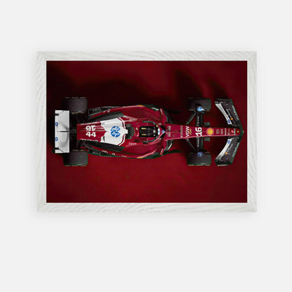 Ferrari F1 2025 Vintage Framed Art showcasing a sleek red racing car on a deep red background.
