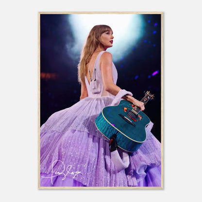 Taylor Swift framed poster in lavender gown, holding a guitar, illuminated on stage, perfect for any fan's collection.