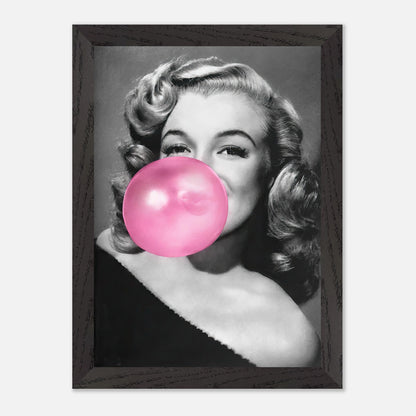 Vintage framed print of Marilyn Monroe blowing a pink bubble gum, adding personality to any wall decor.