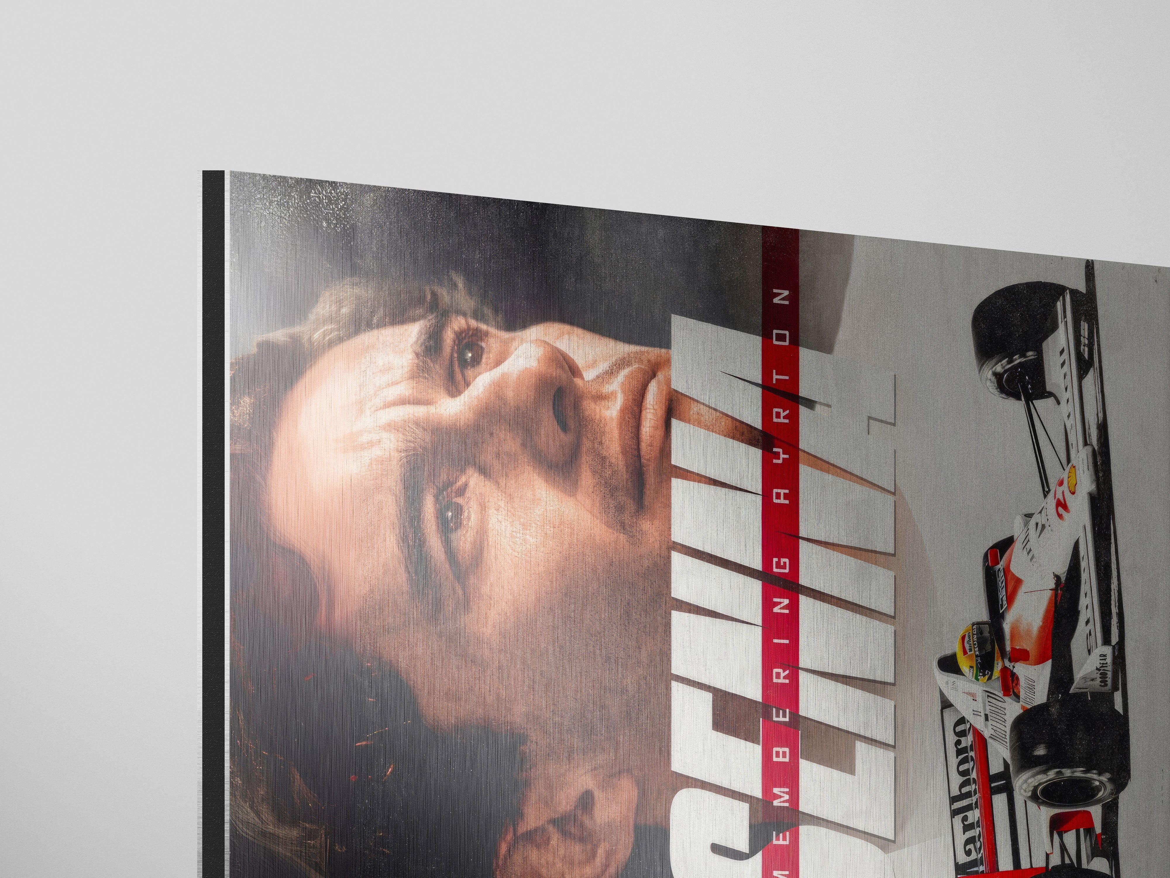 Ayrton Senna Brushed Metal Art featuring a close-up of the racing legend's face with McLaren car details.