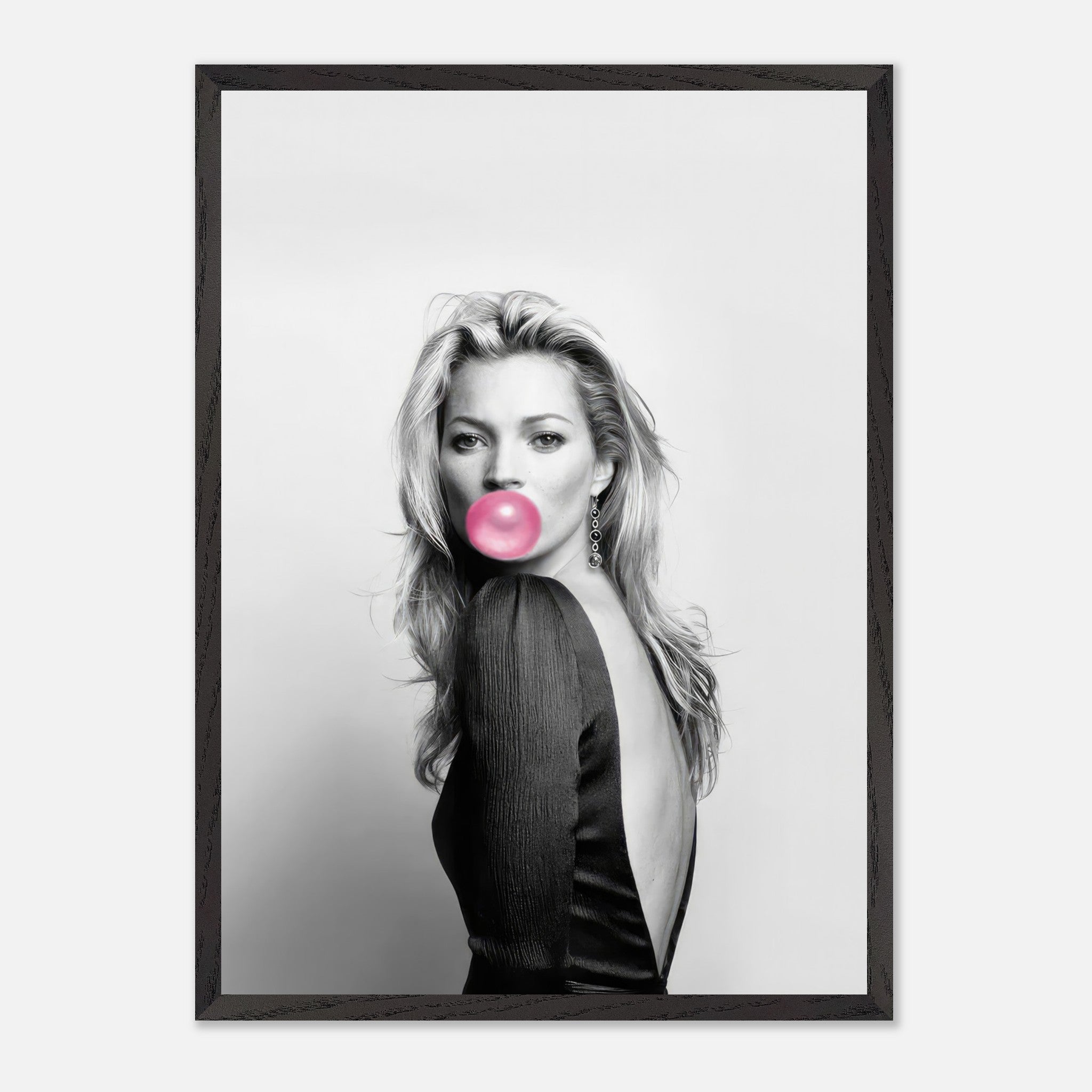 Vintage framed print of a woman blowing pink bubble gum, showcasing iconic fashion photography in black and white.