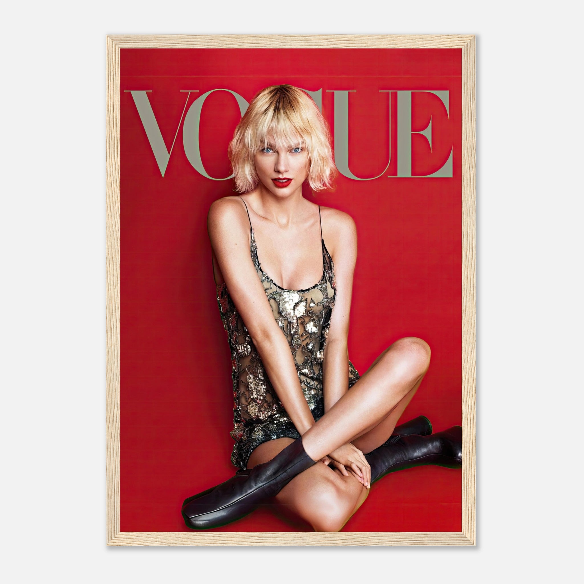 Taylor Swift Vogue framed poster featuring her in a sequined dress on a striking red backdrop. Perfect for fans and collectors.