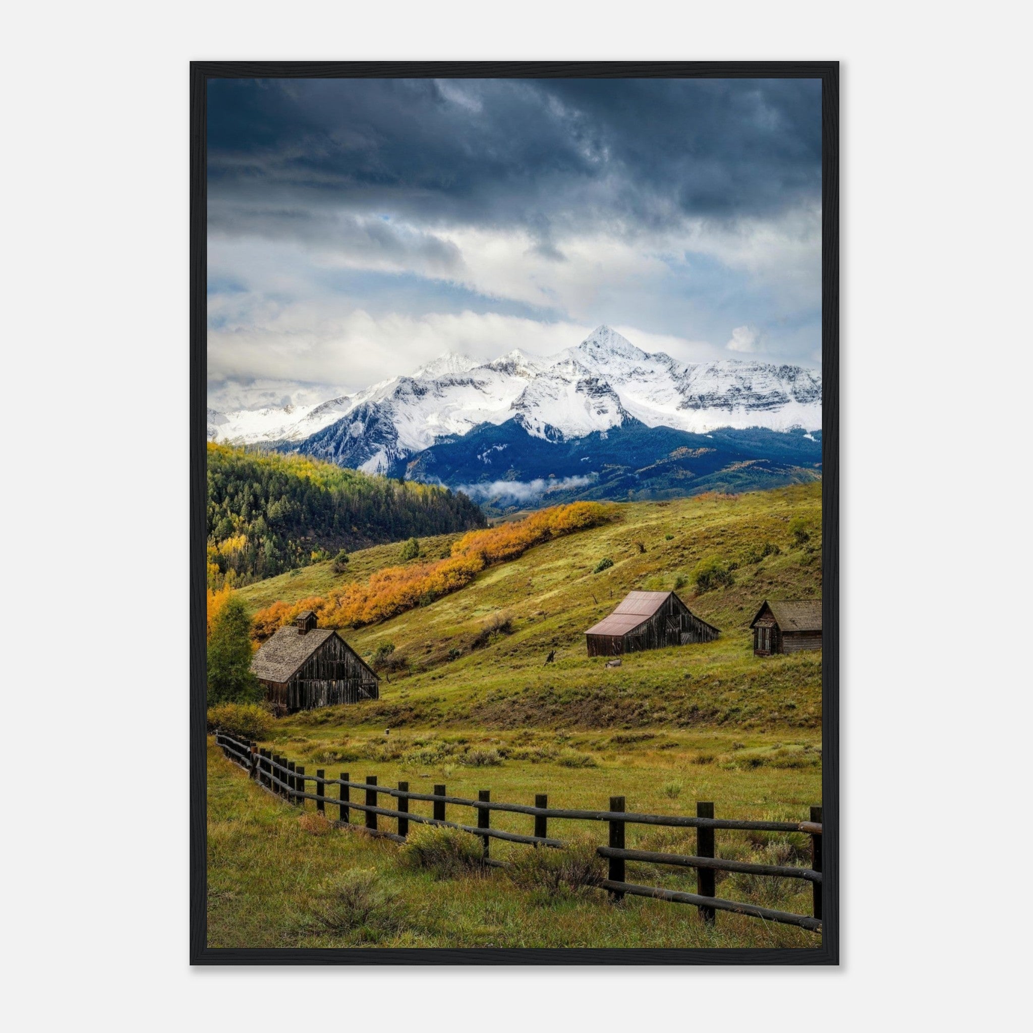 Framed print of Telluride, Colorado showcasing rustic barns and snow-capped peaks amid vibrant fall colors.