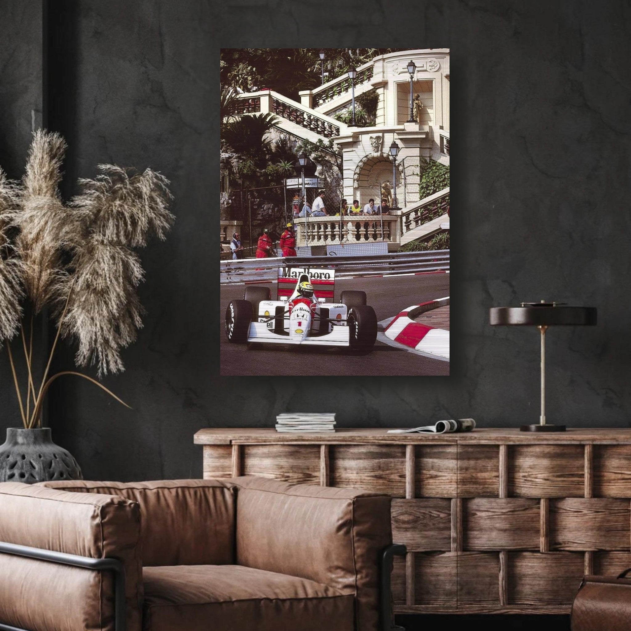 Ayrton Senna racing at Monaco, showcased in a brushed metal print, blending art with motorsport heritage.