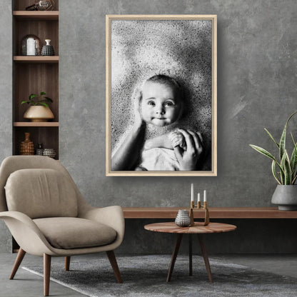 Framed canvas print of a smiling baby in a bubble bath, showcasing warmth and innocence in a modern living room.