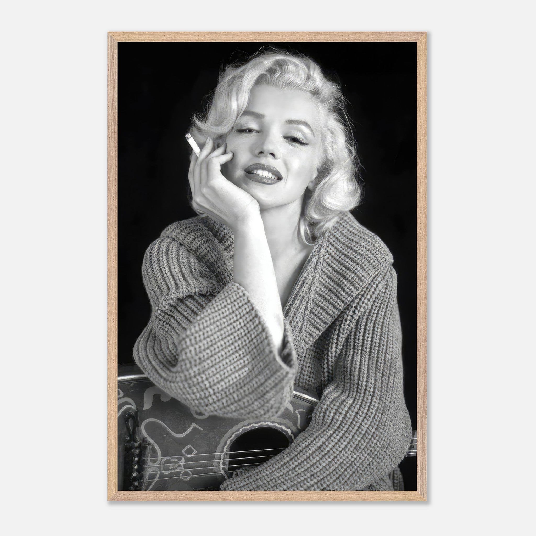 Marilyn Monroe vintage framed print, elegantly posing with a cigarette in a cozy sweater, exuding timeless Hollywood glamour.