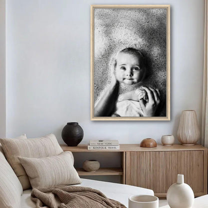 Heartwarming black-and-white baby bath photography framed canvas print in a cozy living room setting.