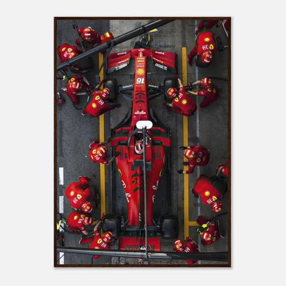 Formula 1 Ferrari pitstop framed print showcasing the dynamic action of the pit crew in vivid red colors.