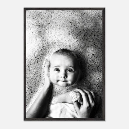 Black-and-white fine art print of a baby in a bubble bath, capturing innocence and joy in childhood.