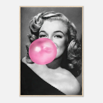 Marilyn Monroe framed print, featuring her blowing pink bubble gum, adding glam and sass to your decor.