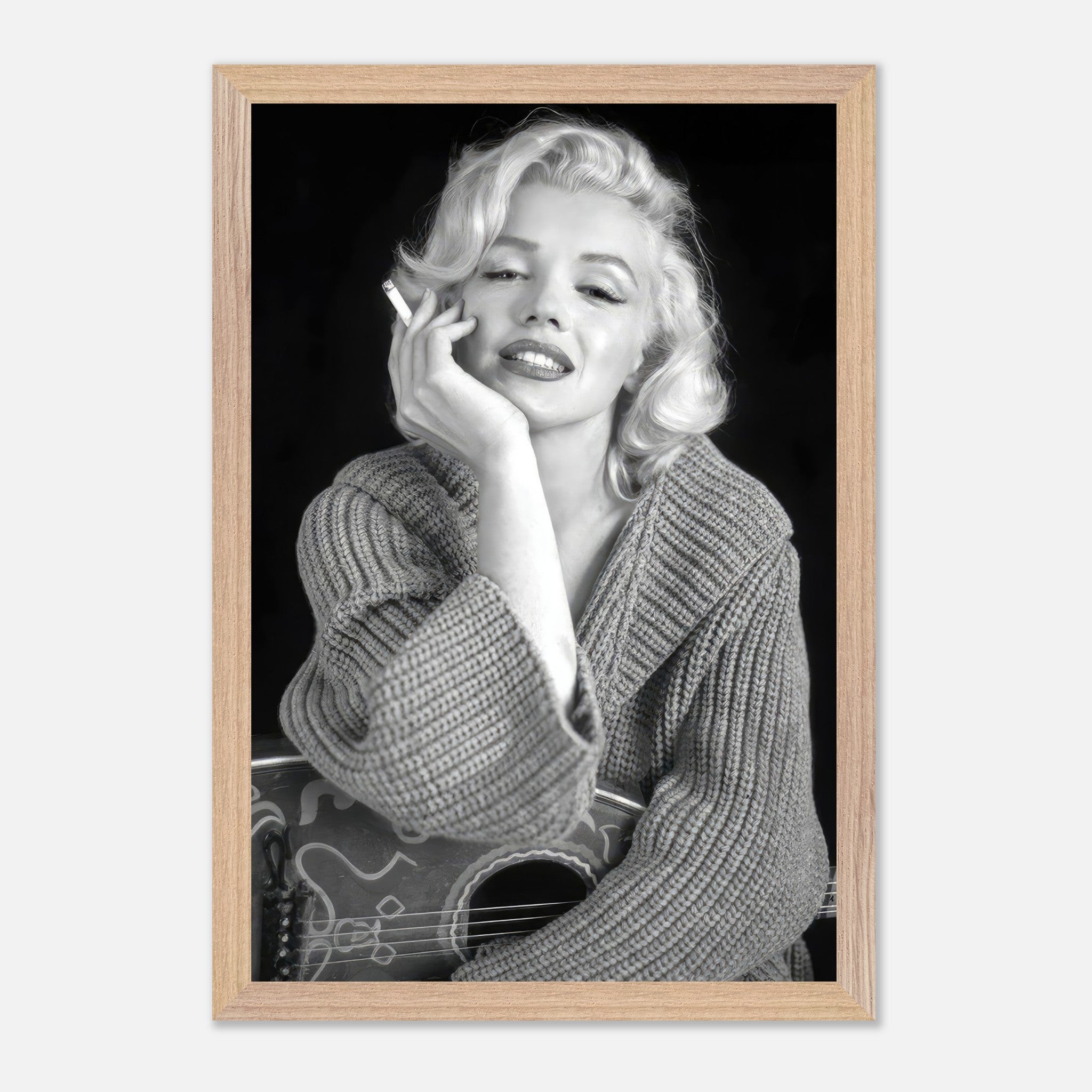 Marilyn Monroe smoking in a cozy sweater, vintage framed print capturing Hollywood glamour and elegance.