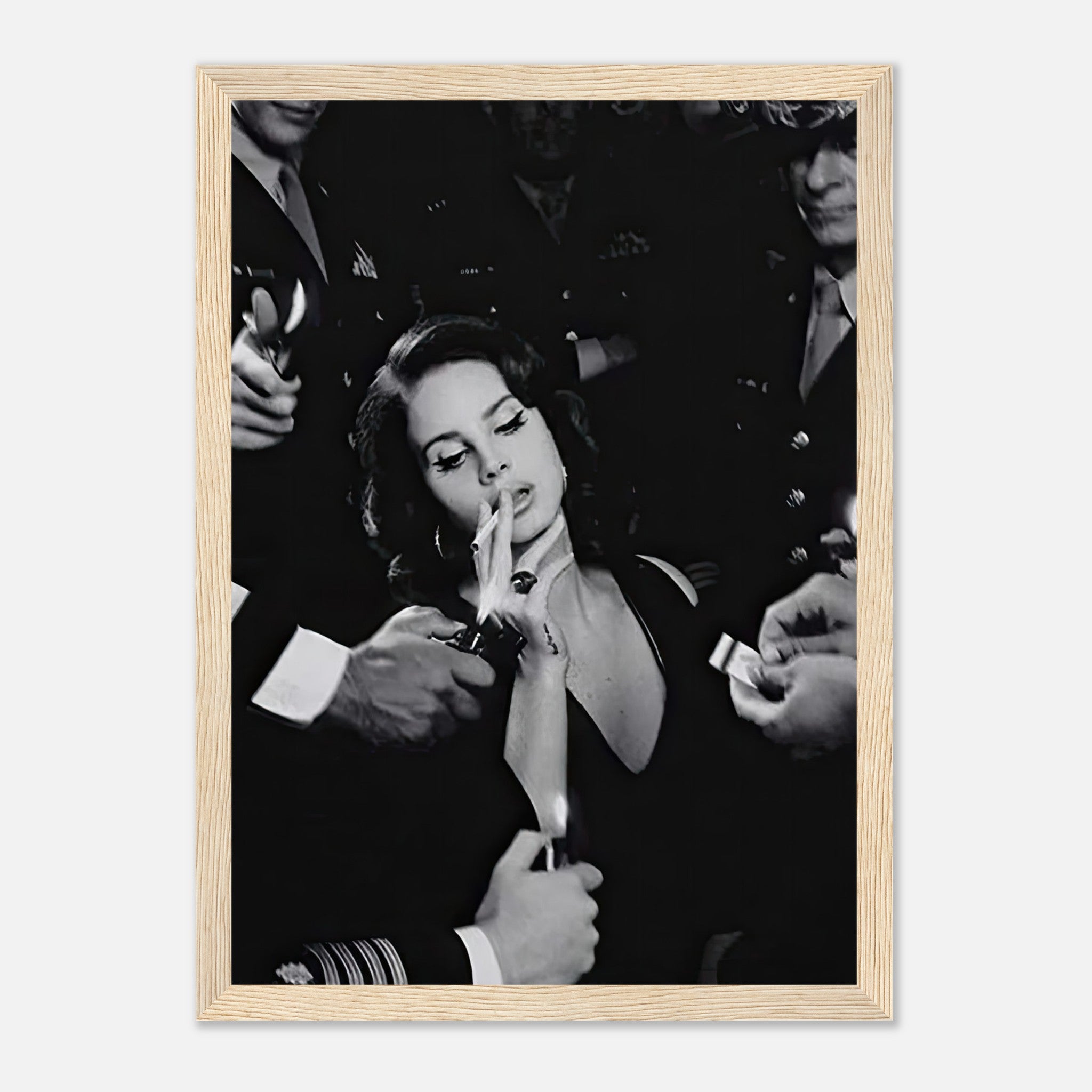 Framed black-and-white print of a woman smoking surrounded by admirers, capturing vintage Hollywood allure.