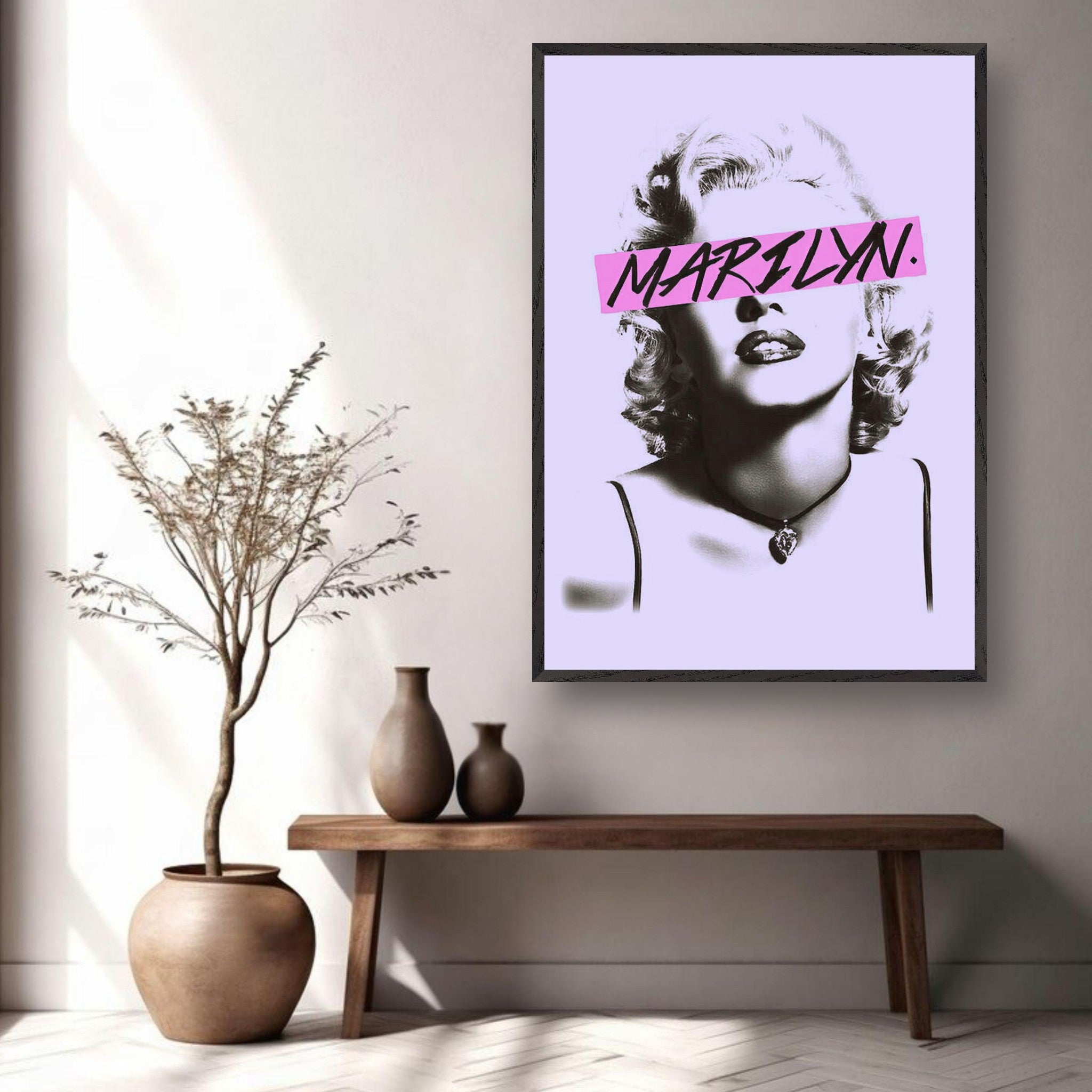 Vintage framed print of Marilyn Monroe with pink graphic detail, displayed in a stylish living room setting.