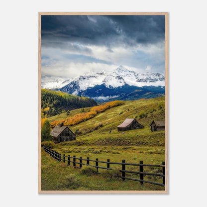 Framed Giclée fine art print of Telluride, Colorado with rustic barns and snow-capped mountains under a dramatic sky.