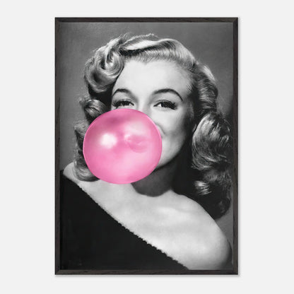 Vintage framed print of Marilyn Monroe blowing a pink bubble gum, adding a playful touch to home decor.