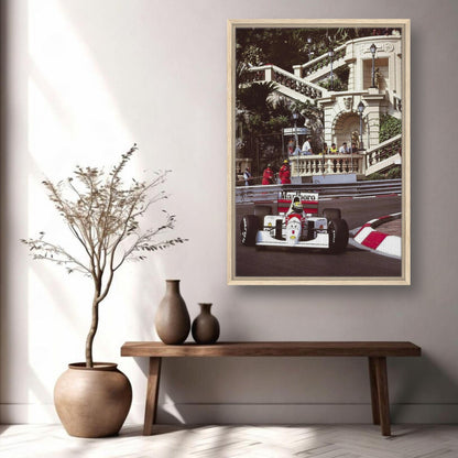 Framed canvas print of Ayrton Senna racing in Monaco, showcased in a stylish living room setting.