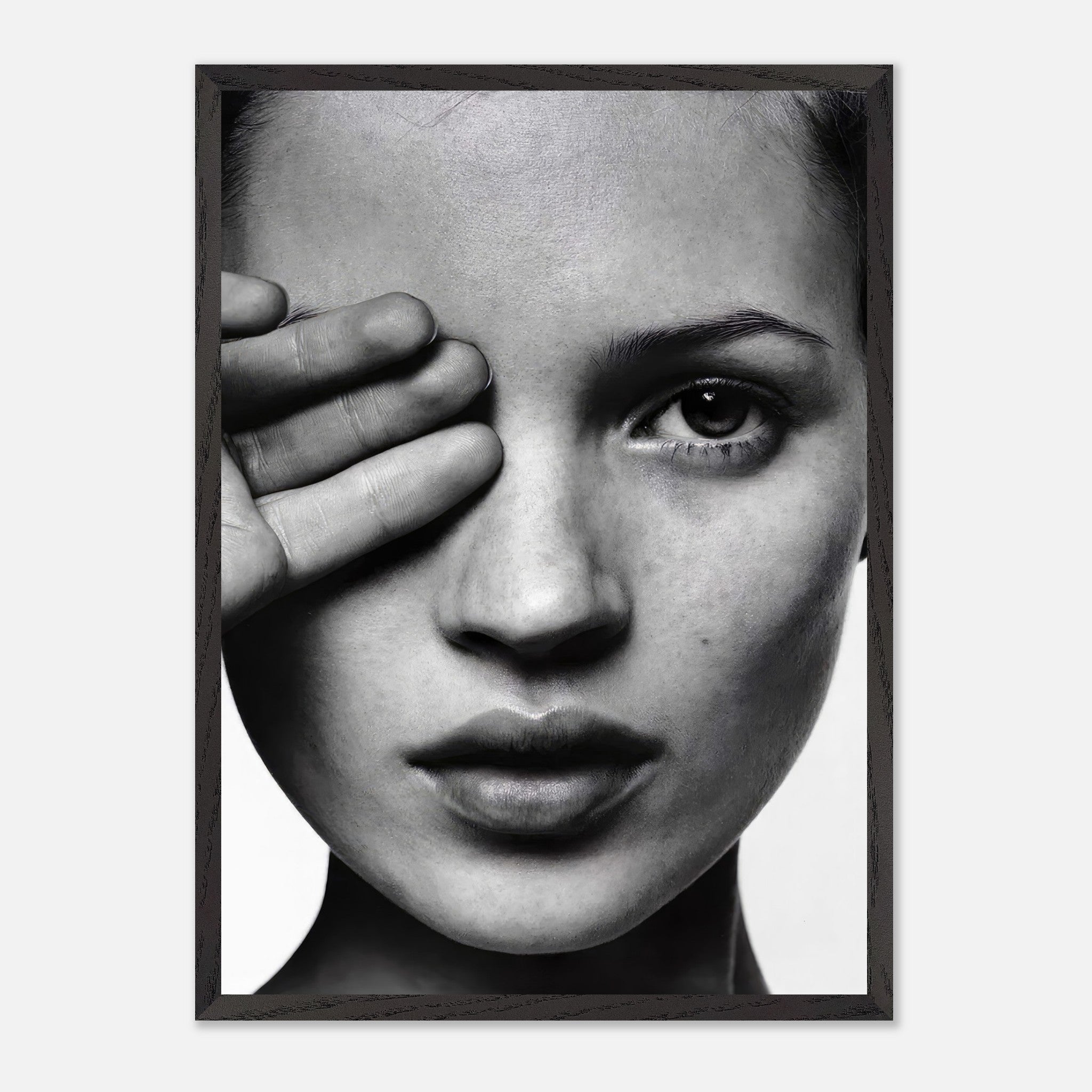 Kate Moss black and white vintage framed print featuring a captivating close-up of her face with a hand covering one eye.