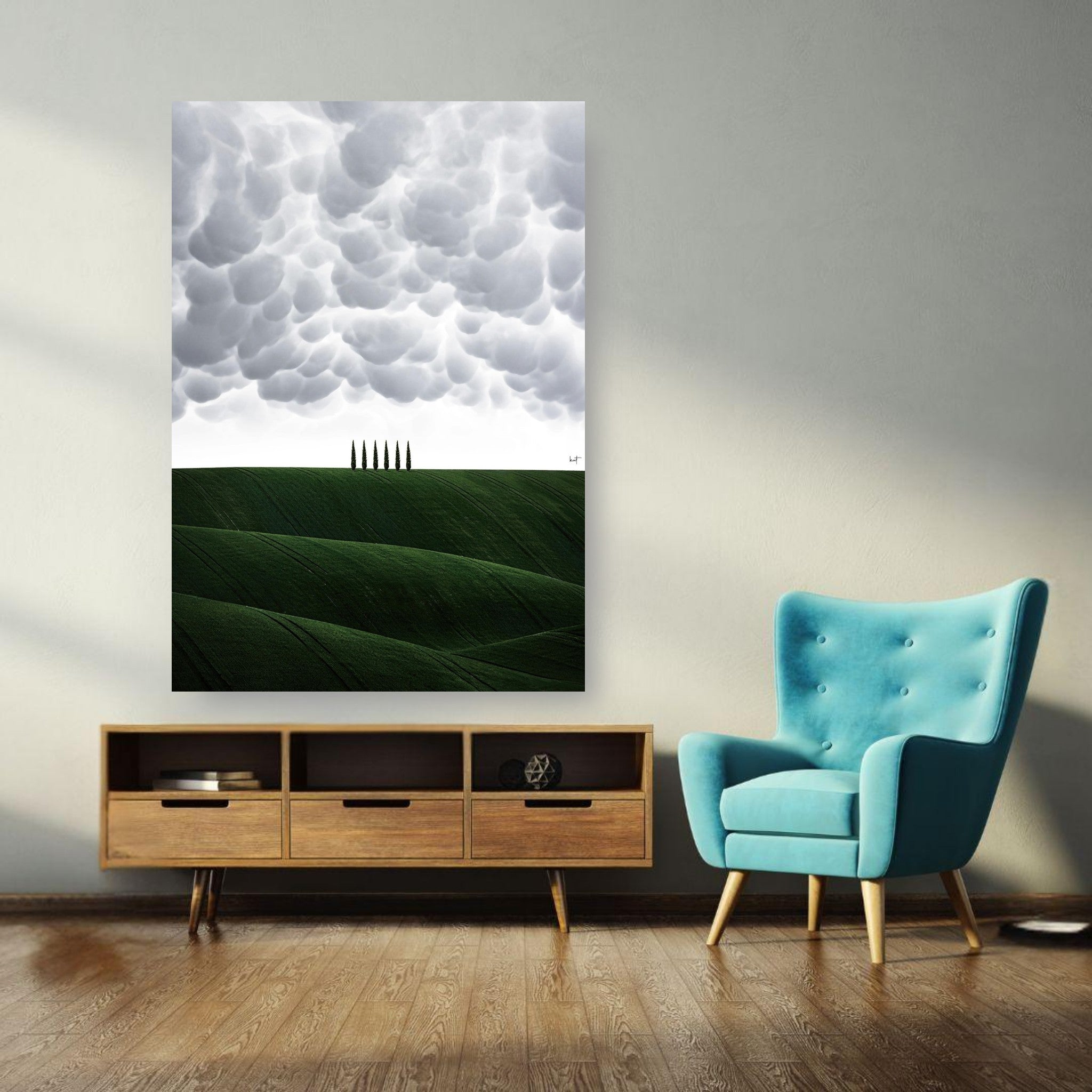 Toscana Italy poster featuring rolling green hills and cypress trees under dramatic clouds in a stylish living room setting.