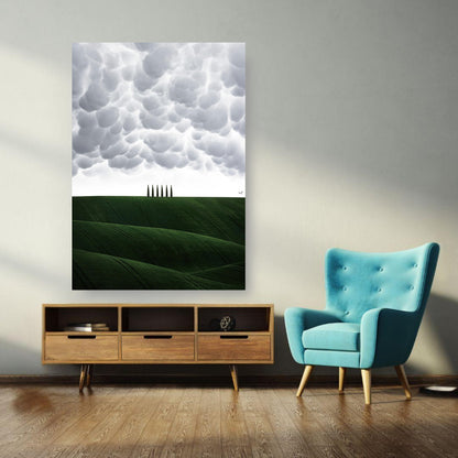 Toscana Italy poster featuring rolling green hills and cypress trees under dramatic clouds in a stylish living room setting.