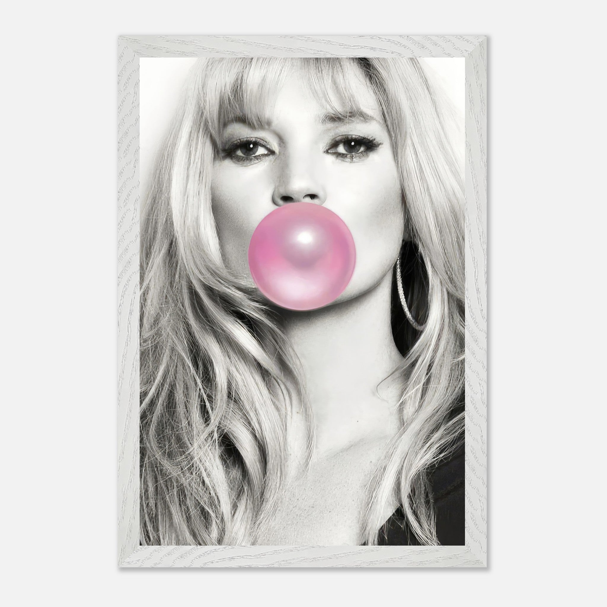 Black-and-white portrait of Kate Moss blowing pink bubble gum in a vintage framed print, adding a playful touch to modern decor.