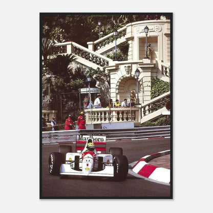 Ayrton Senna racing at the Monaco Grand Prix in a framed print, showcasing iconic motorsport moments and vibrant street scenery.