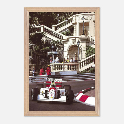 Framed fine art print of Ayrton Senna racing in Monaco, showcasing his iconic McLaren during a thrilling moment on the track.