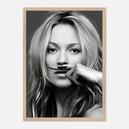 Black-and-white framed print of a woman with a playful mustache, capturing vintage fashion style and humor.