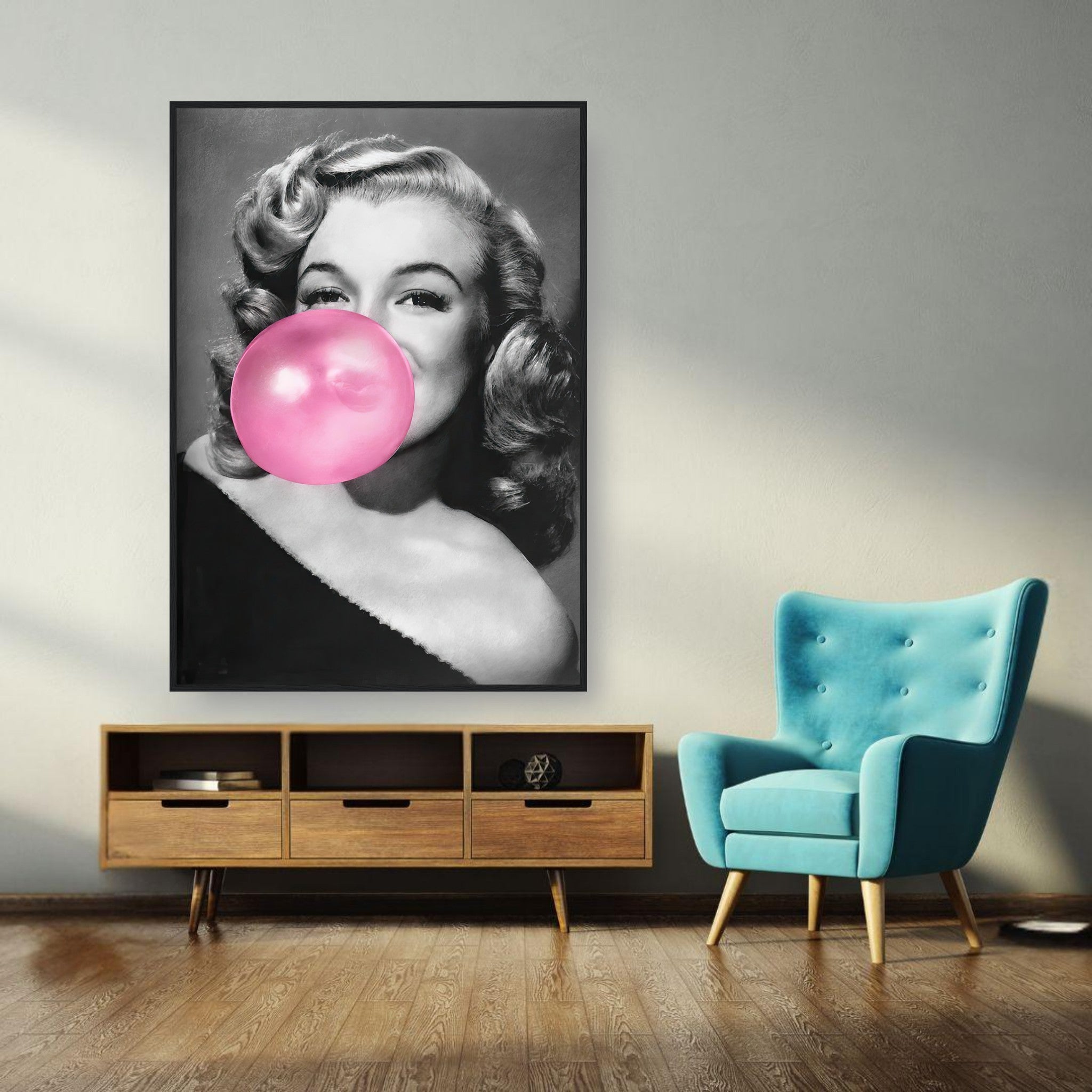 Framed print of Marilyn Monroe blowing bubble gum, adding a pop of glamour and sass to home décor.