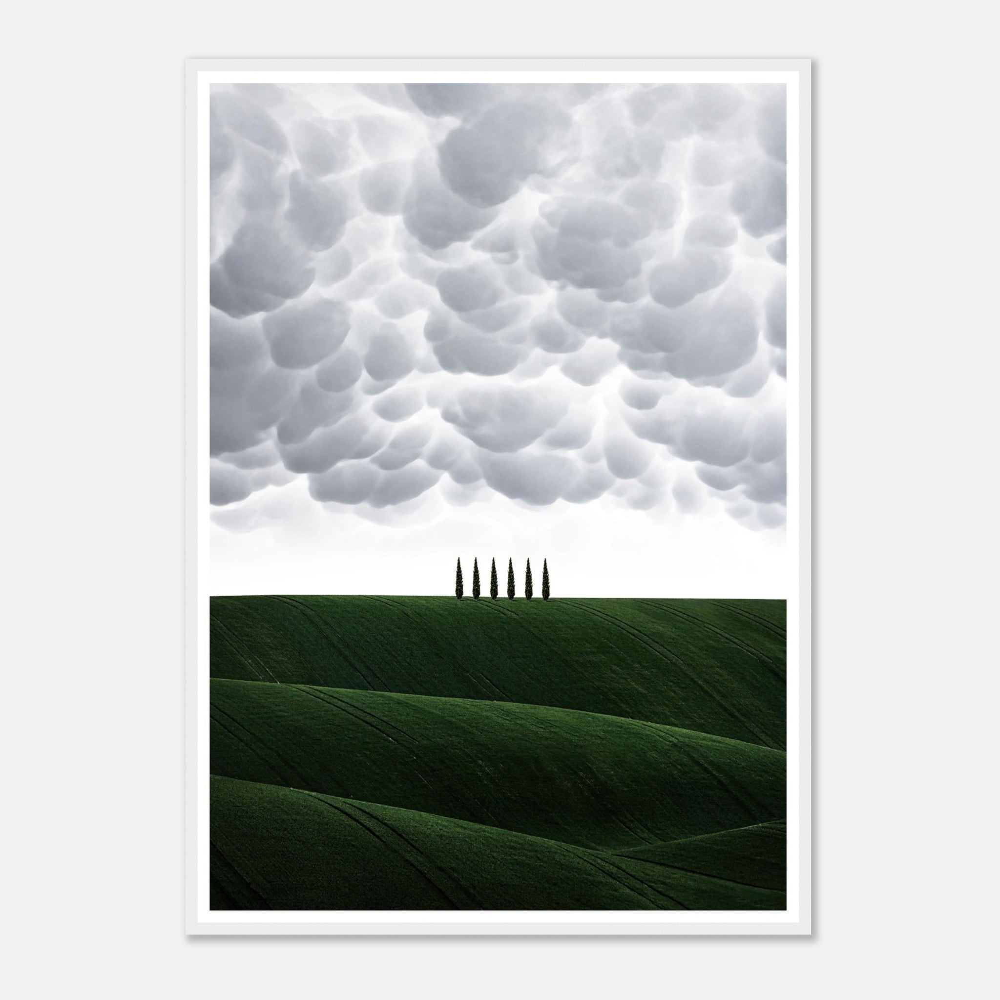 Framed print of Tuscany, Italy featuring green hills, cypress trees, and dramatic cloud formations.