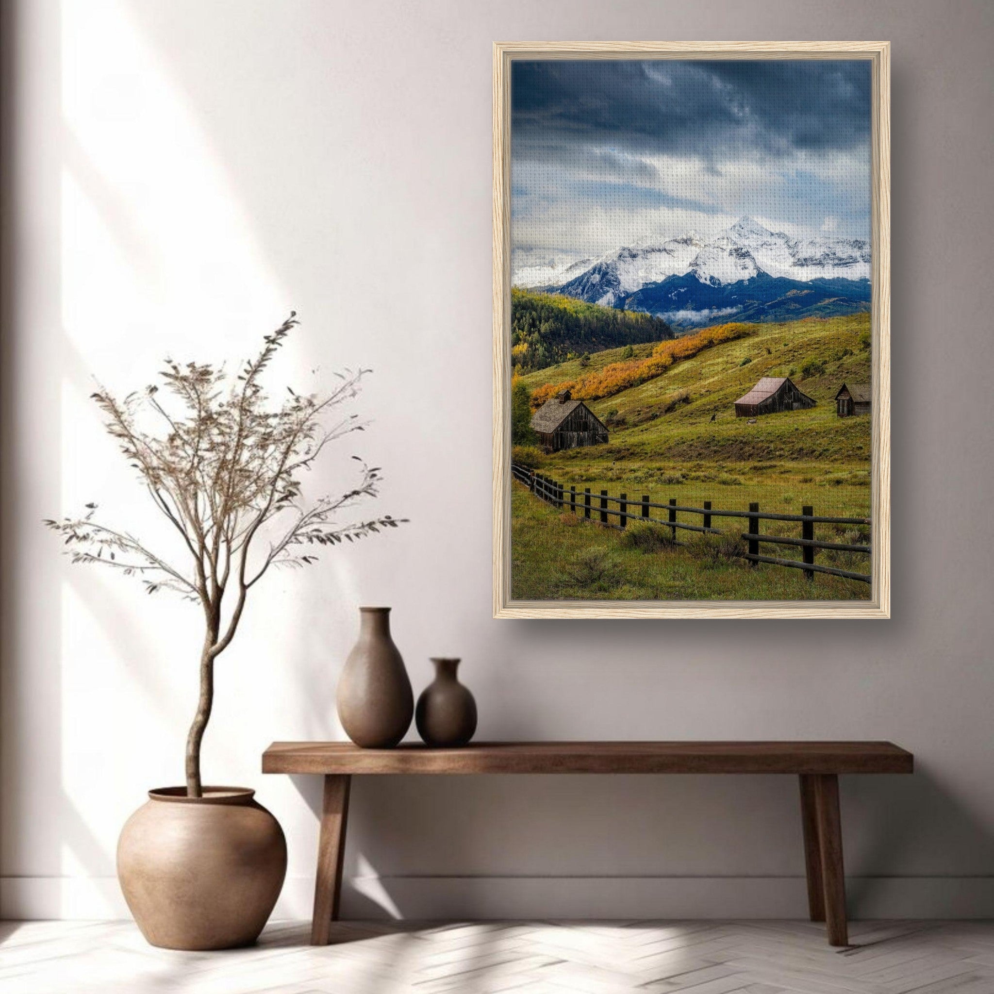 Framed canvas print of Telluride, Colorado, featuring snow-capped mountains and rustic barns in a serene setting.