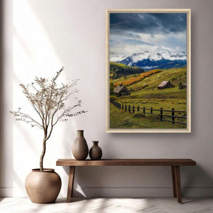 Framed canvas print of Telluride, Colorado, featuring snow-capped mountains and rustic barns in a serene setting.