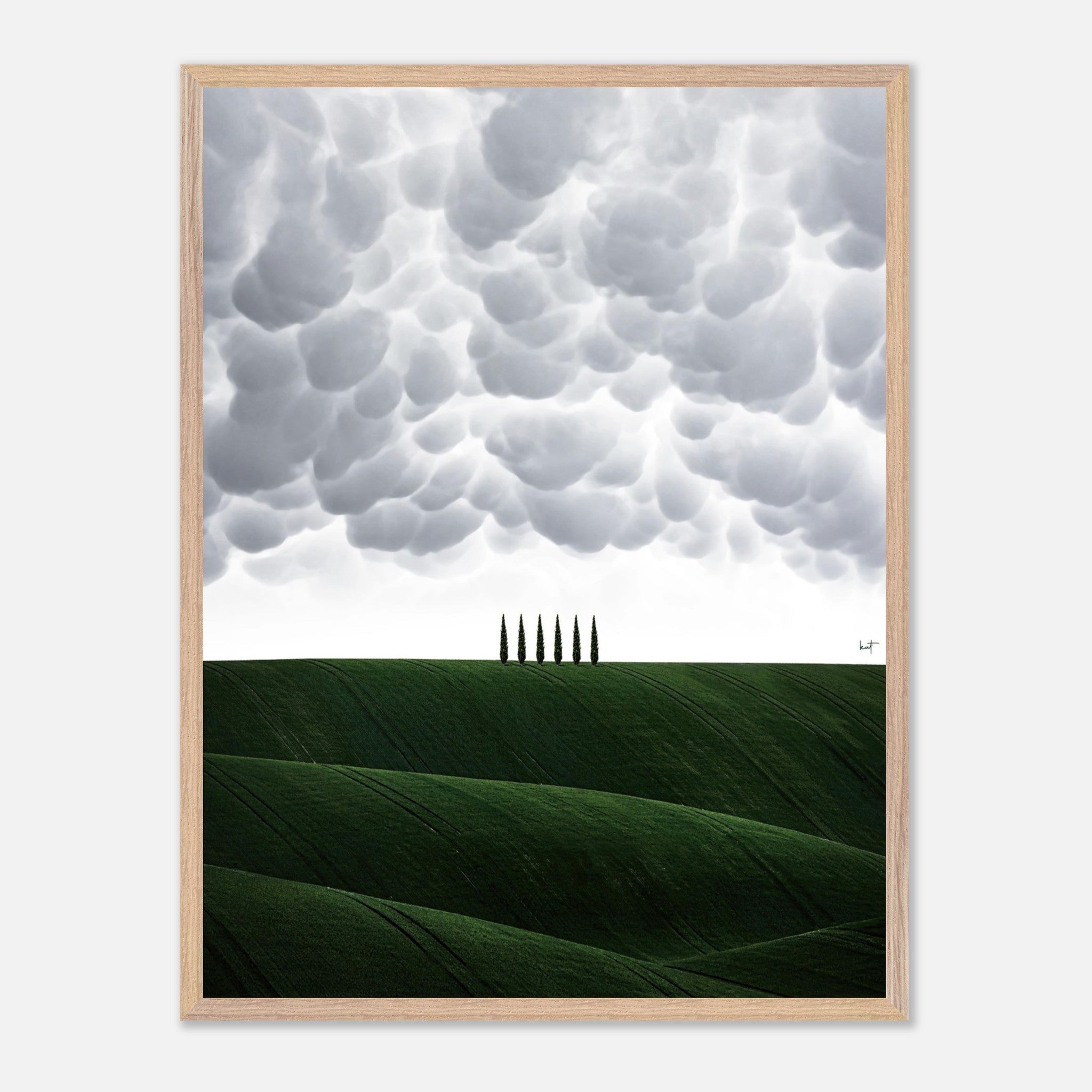 Vintage framed art of Tuscan hills with cypress trees under a dramatic sky, evoking tranquility and elegance.