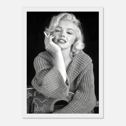 Marilyn Monroe smoking in a cozy sweater, black-and-white framed poster exuding elegance and Hollywood allure.