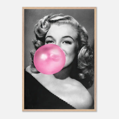 Vintage framed print of Marilyn Monroe blowing a pink bubble gum, showcasing sass and style in wall art.