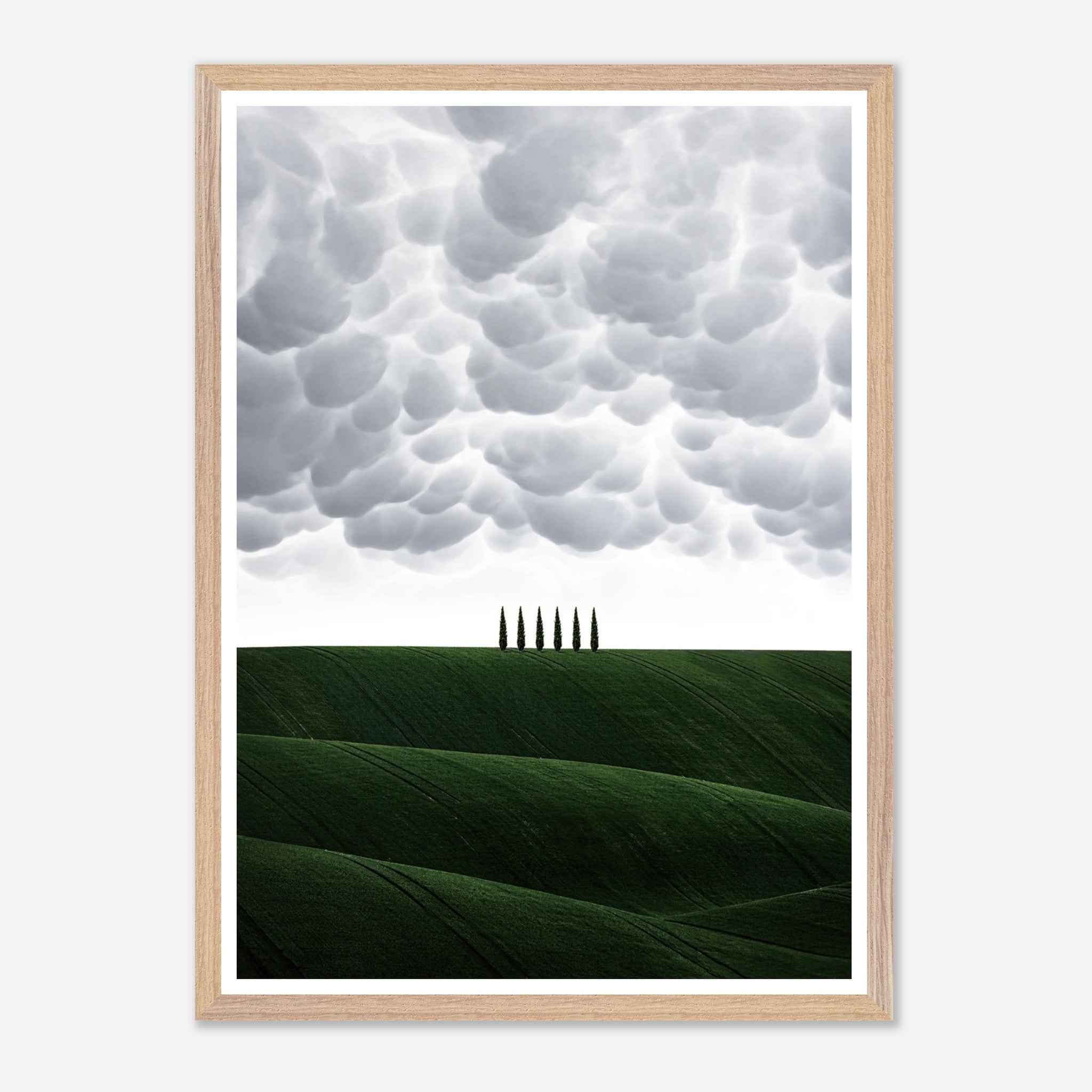 Toscana vintage framed art featuring green hills and cypress trees under a dramatic sky. Perfect decor for any room.