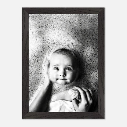 Serene baby in bubbles captured in vintage black and white framed print, evoking nostalgic innocence.
