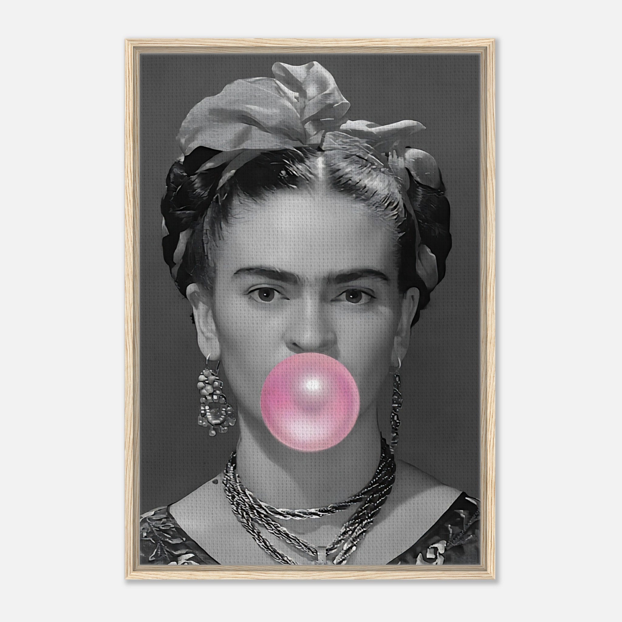 Frida Kahlo framed canvas print with grayscale portrait and pink bubble gum bubble, set in natural wood frame.